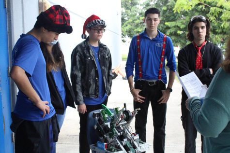 Members of the Buccaneer Robotics team wait outside during a break in the competition.