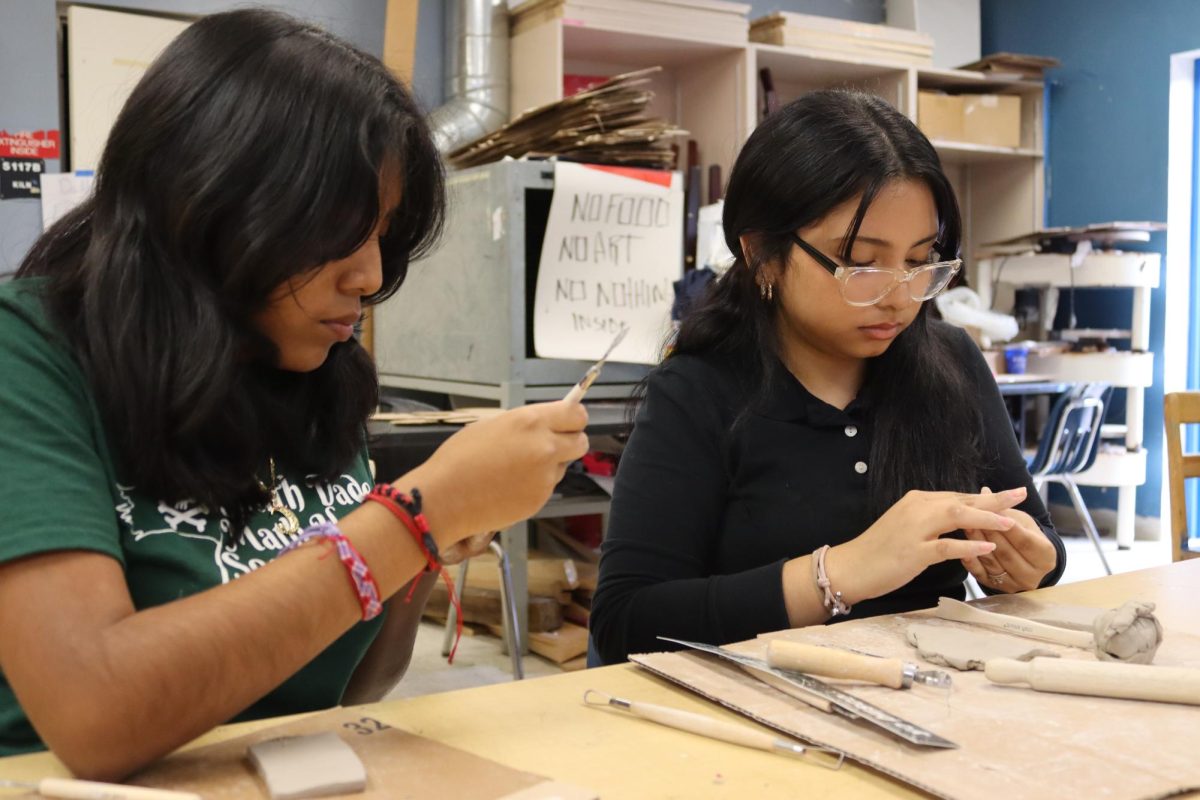 Art students sculpt rectangle shapes to create yearbook themed ornaments for SD Bucs Media. 