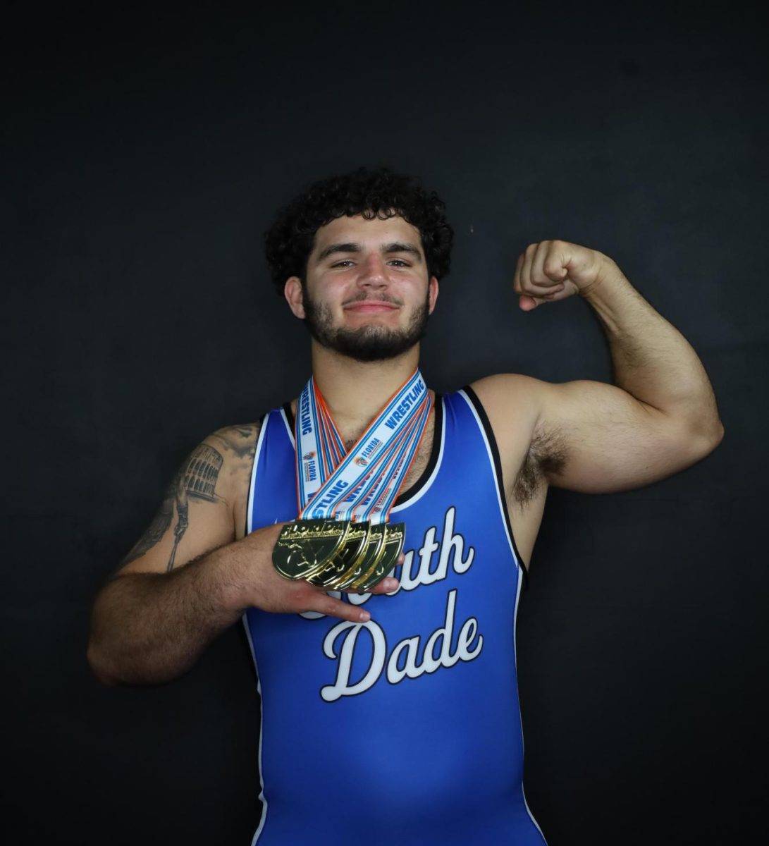 Senior Sawyer Bartelt, 4x state champion, with his state championship medals.