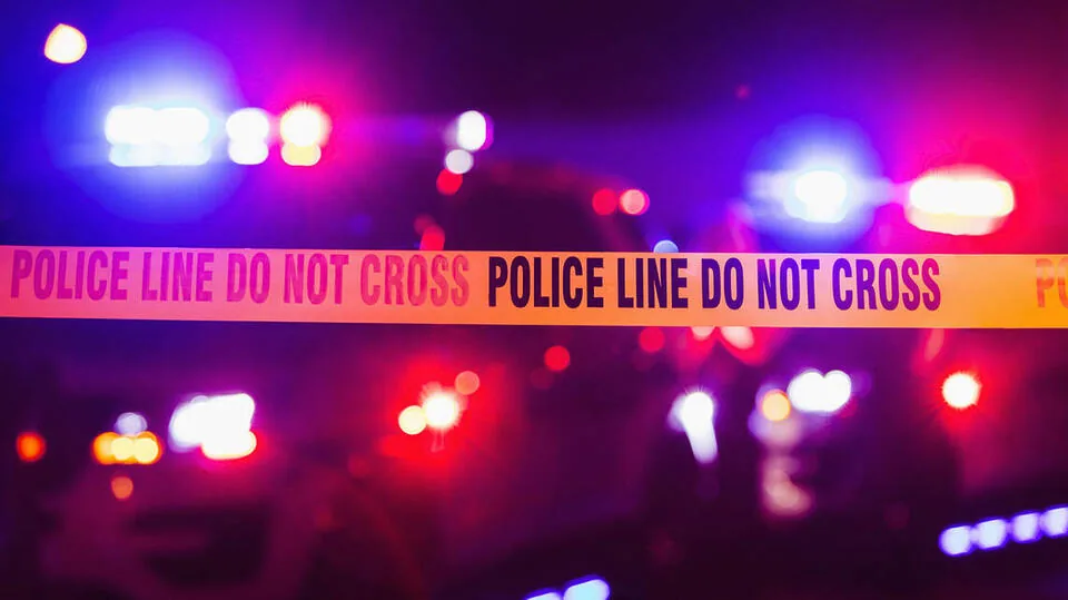 Police lights near an apartment complex in Miami-Dade County after an alleged arson attack