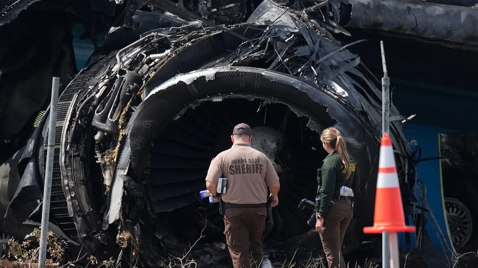Investigators review the Amazon Air cargo plane crash scene near a Miami runway
